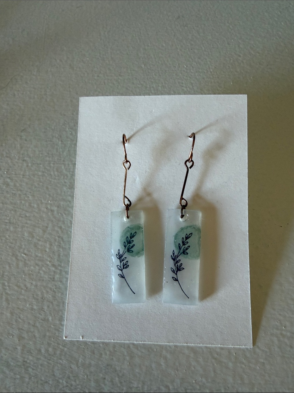 Handmade White Resin Earrings with Green Leaf Design